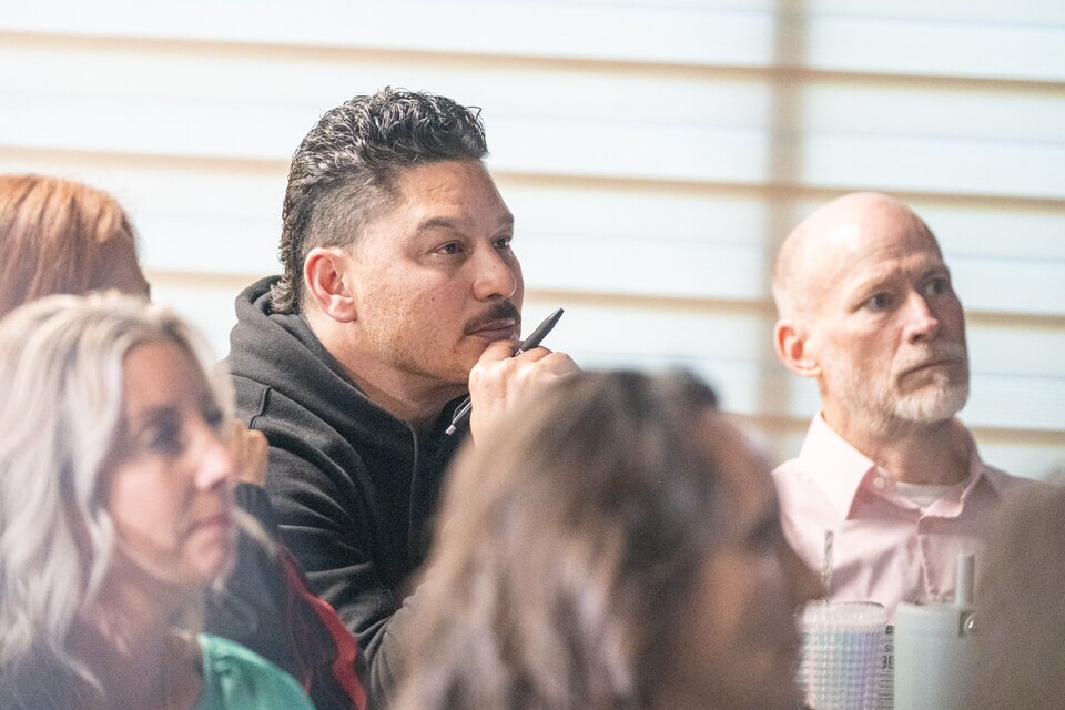 Attendees listening and taking notes during a March TELŌS session